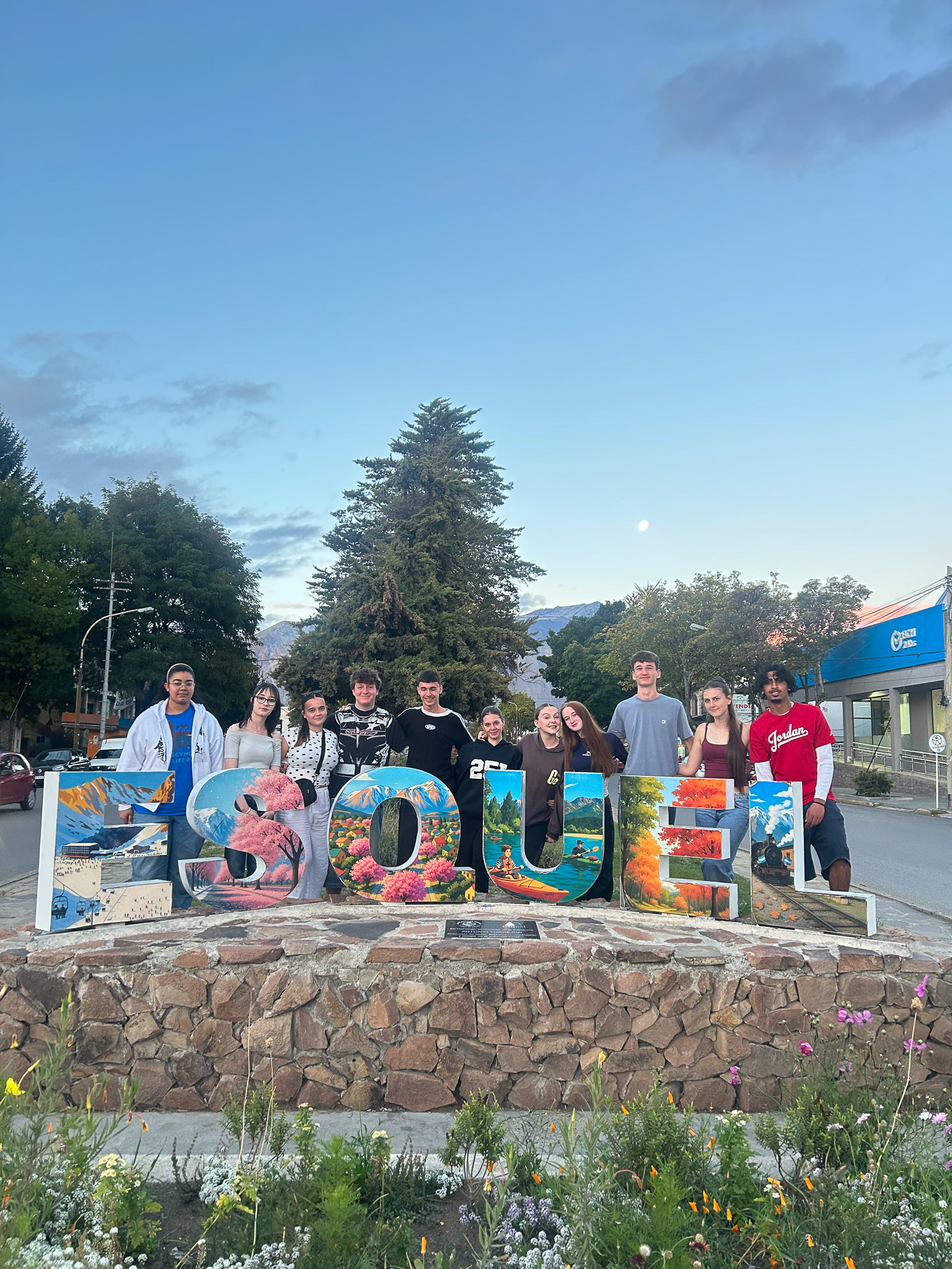 St David's students in front of Esquel sign in Patagonia.