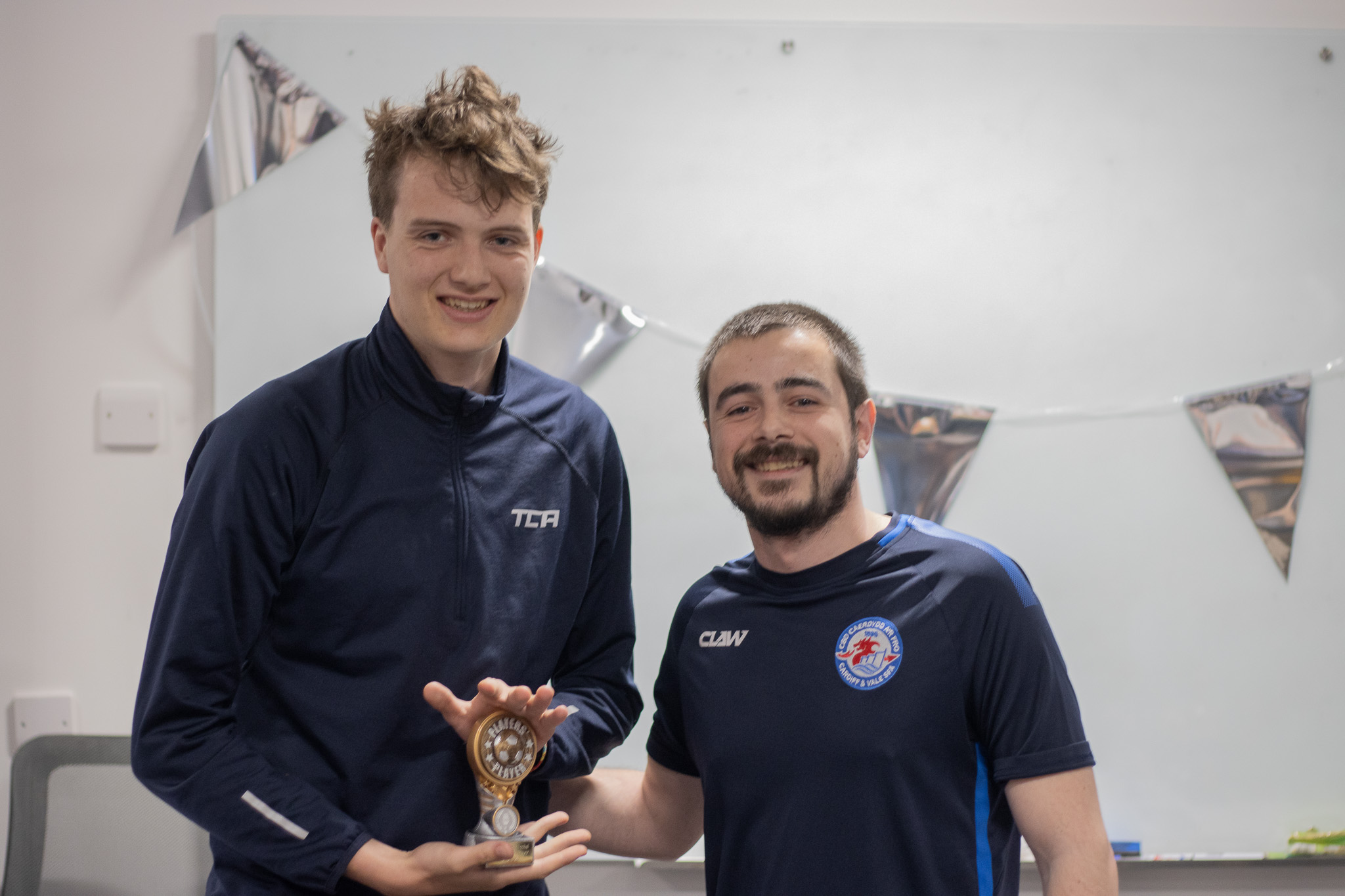 Football player with award at St David's Sports Awards