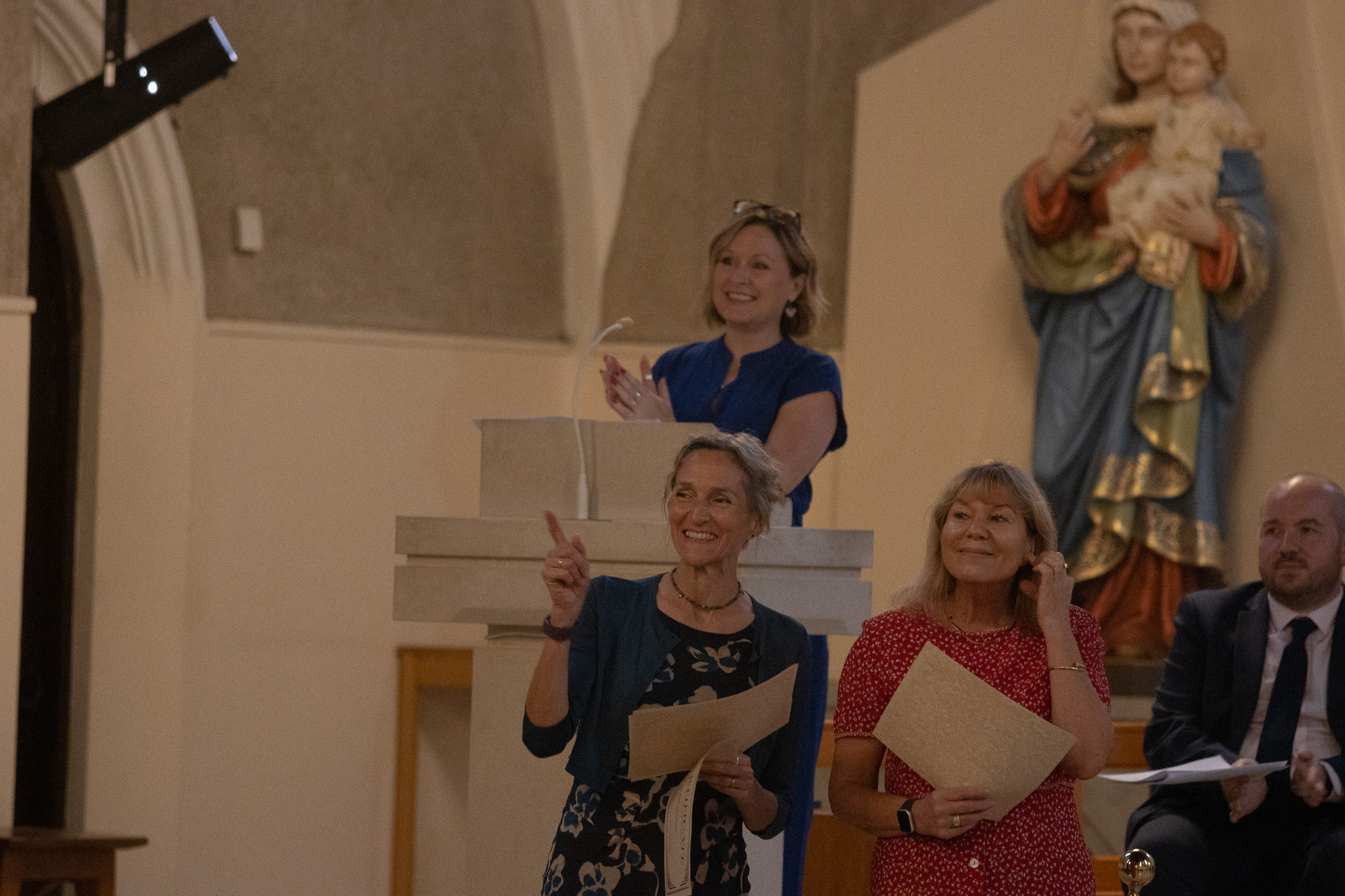 Staff holding awards in Cardiff Cathedral for the leavers celebration