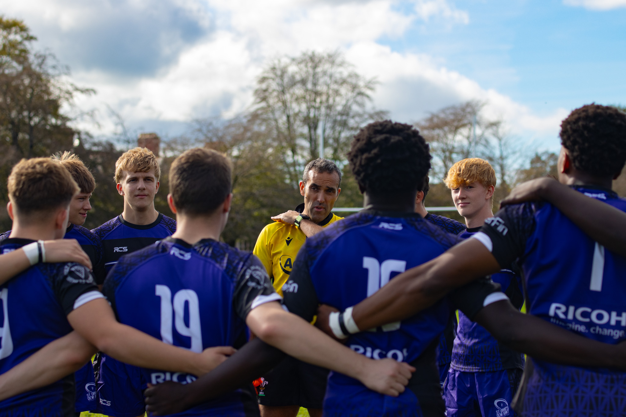 St David's College rugby team in a huddle